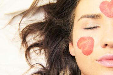 A woman with heart illustrations on her face.